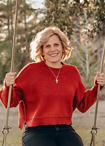 Smiling woman on a swing